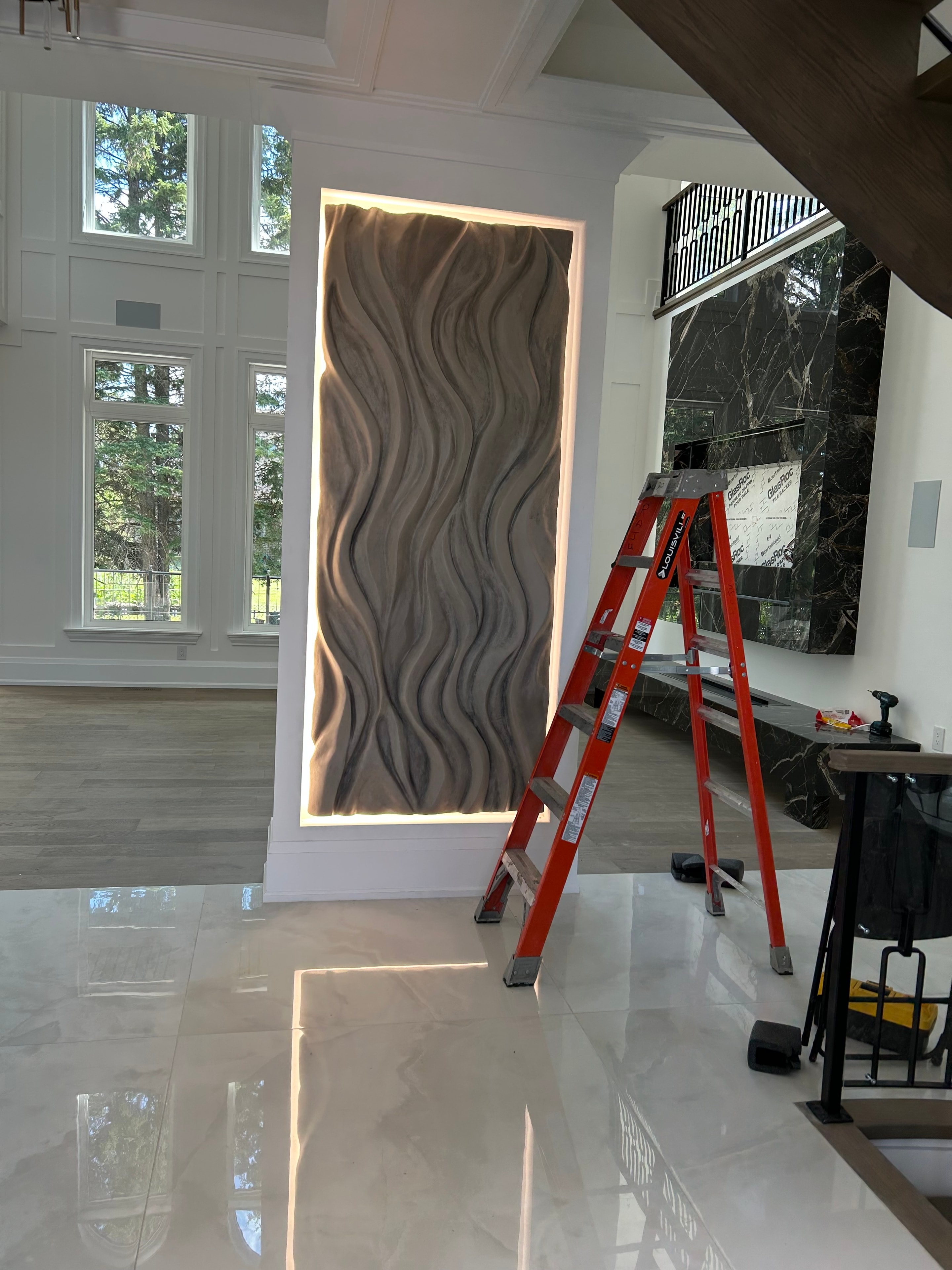 Installation in progress — ODAY FORM sculptural wall panel with LED backlight